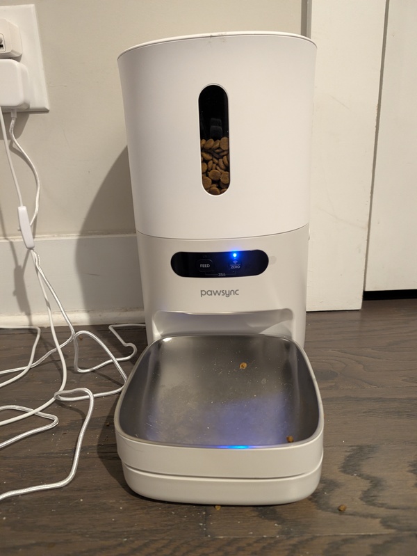 PawSync smart pet feeder with food in the hopper and bowl