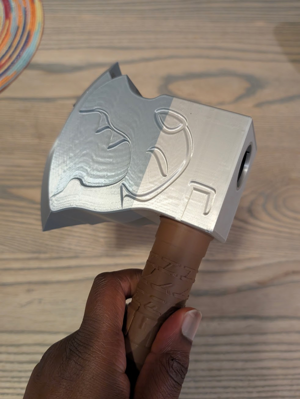 Close-up of the axe head's engraved face, held in hand